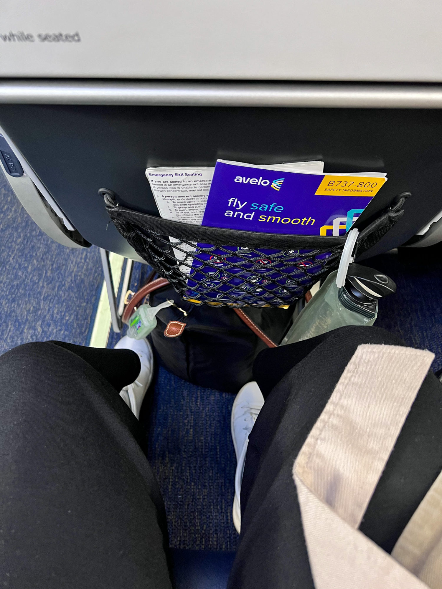 Flying Avelo for the First Time? 13 Insider Tips You Need to Know Before You Book Alyssa's feet are seen while sitting in her seat on Avelo